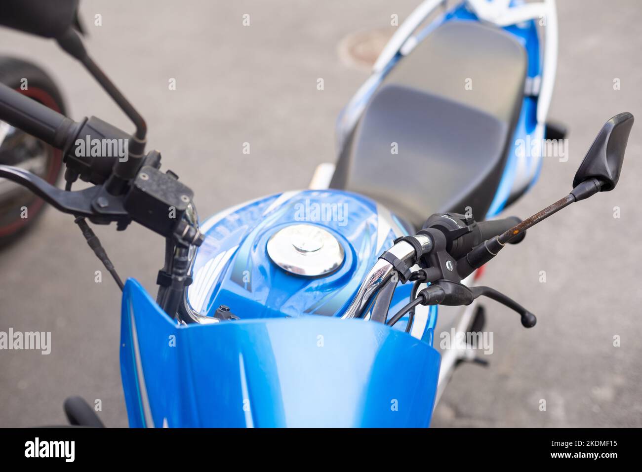 Blue moped, The spotlight of a moped is large Stock Photo - Alamy