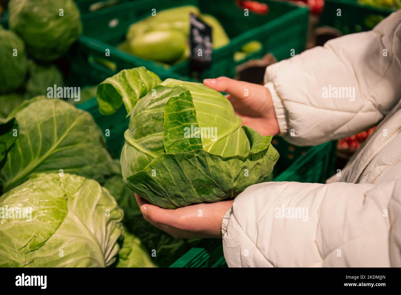 A woman chooses cabbage in a grocery store, close-up Stock Photo - Alamy