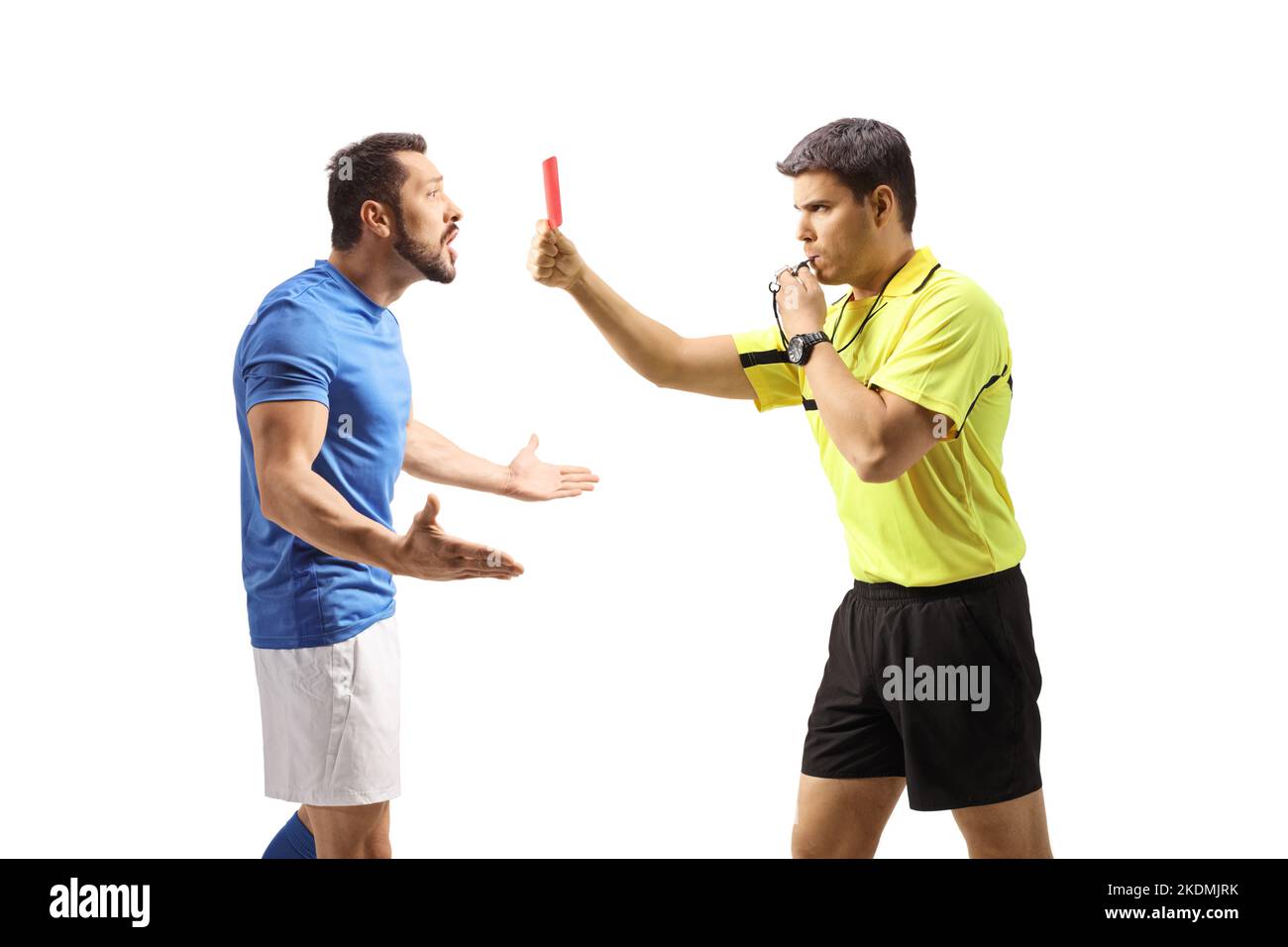 Profile shot of a football referee blowing a whistle and showing a red