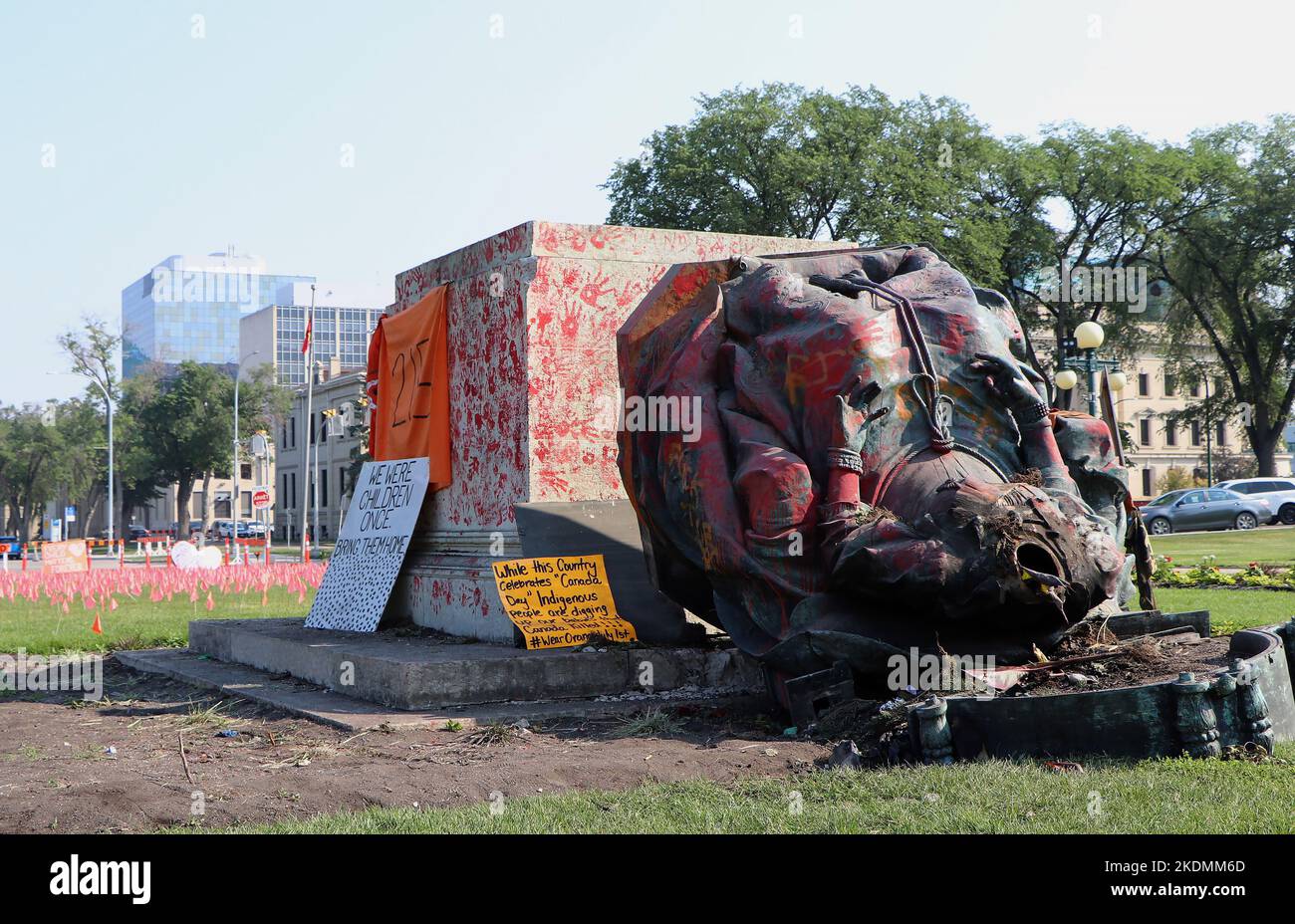 A headless statue of Queen Victoria is seen overturned and vandalized at the provincial