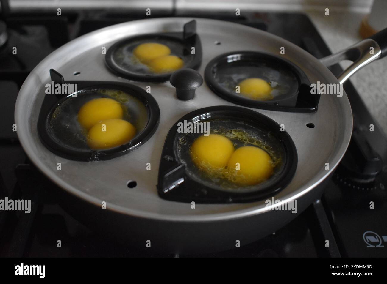 An egg poacher, with three sets of double yoked eggs Stock Photo Alamy