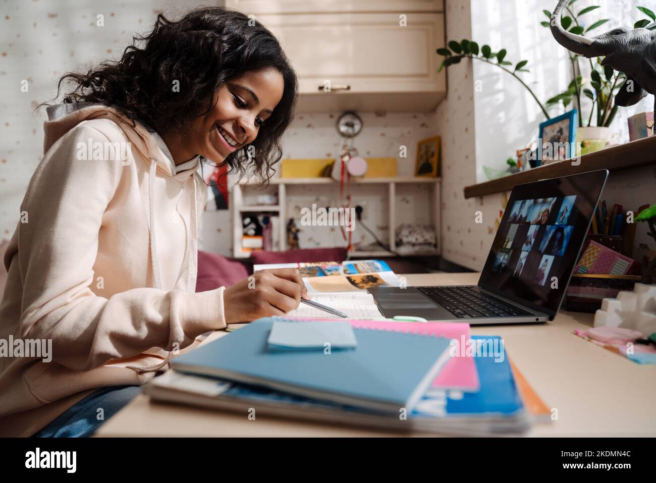 African cute smiling teen girl with laptop studying at home Stock Photo ...