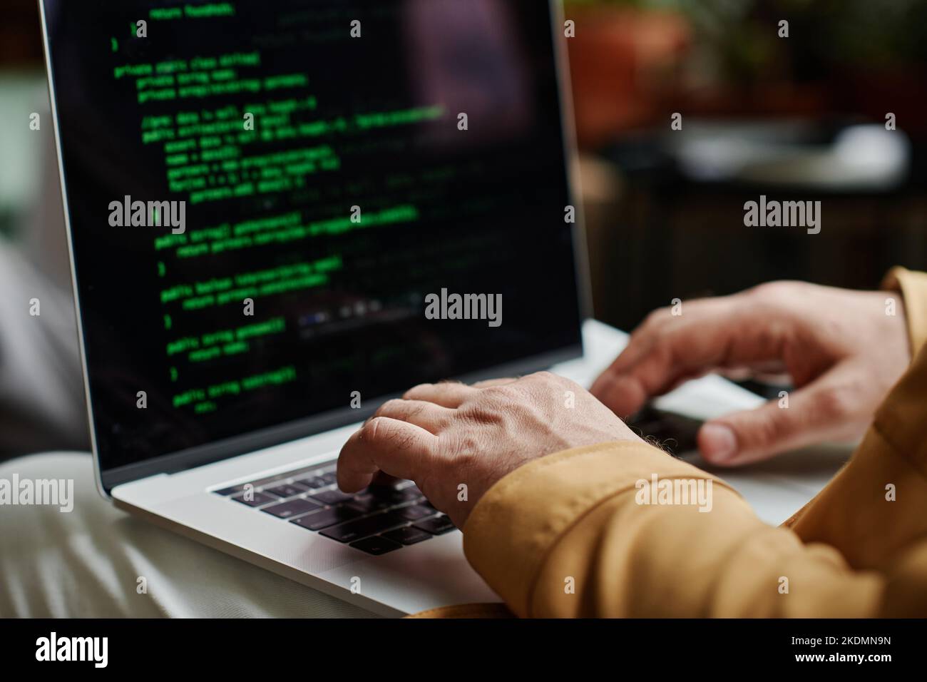 Hands of modern programmer or software developer typing on laptop keyboard while decoding data or working over new IT project Stock Photo