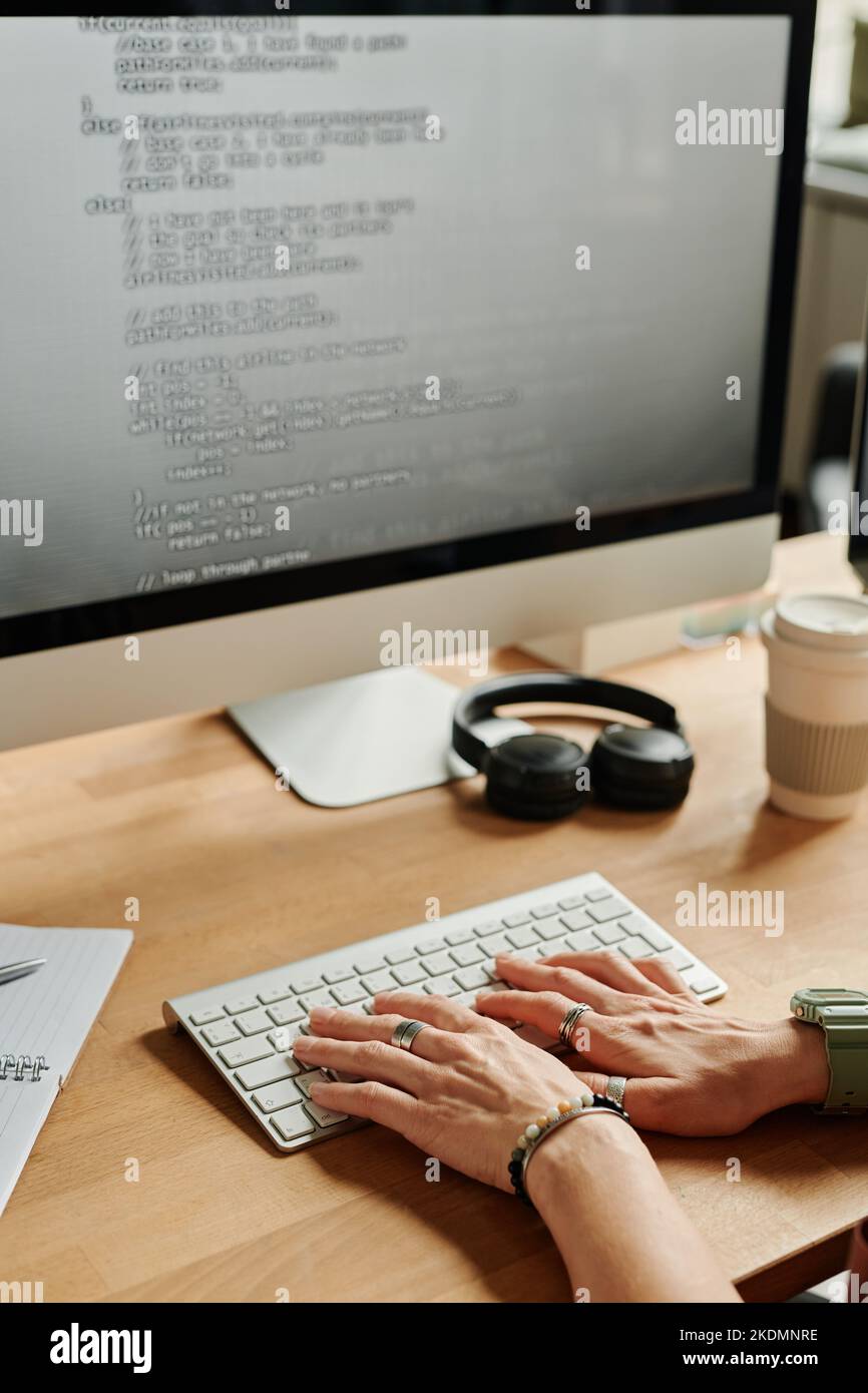 Young businesswoman or programmer pressing keys of computer keyboard ...