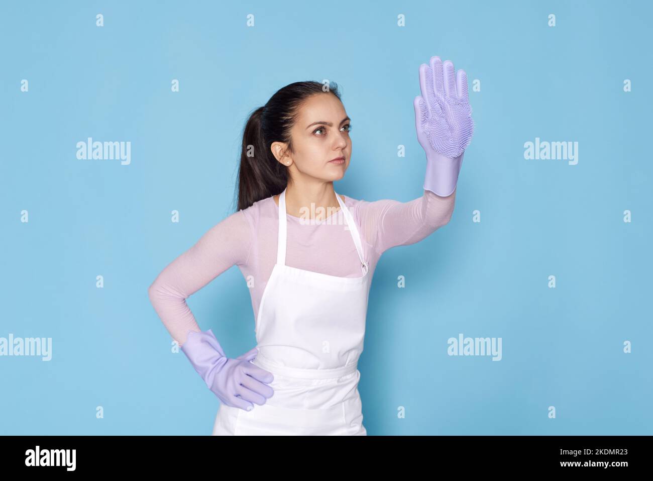 Woman in purple rubber gloves cleaning electric kettle with sponge Stock  Photo - Alamy