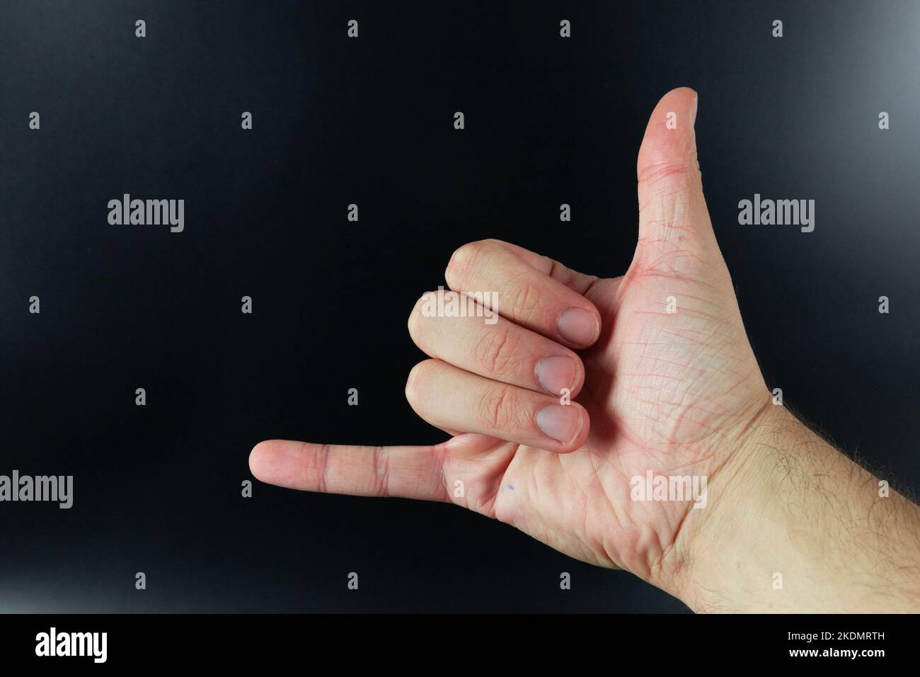 Call me sign isolated on background. Shaka sign, hang loose, right on or hang ten gesture. Stock Photo