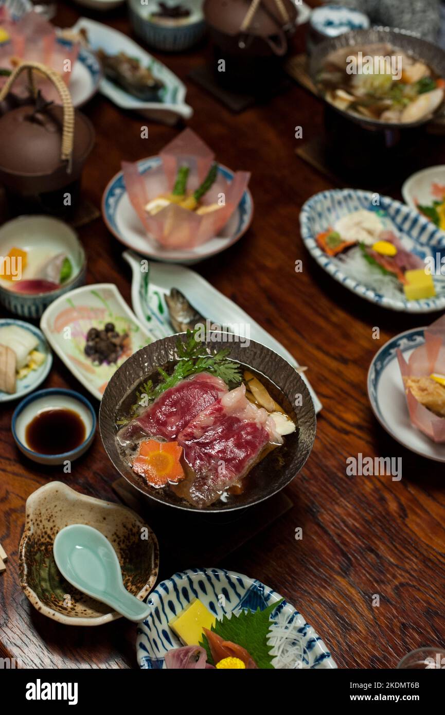 A traditional Japanese ryokan meal, featuring sukiyaki cooked in individual portions, and