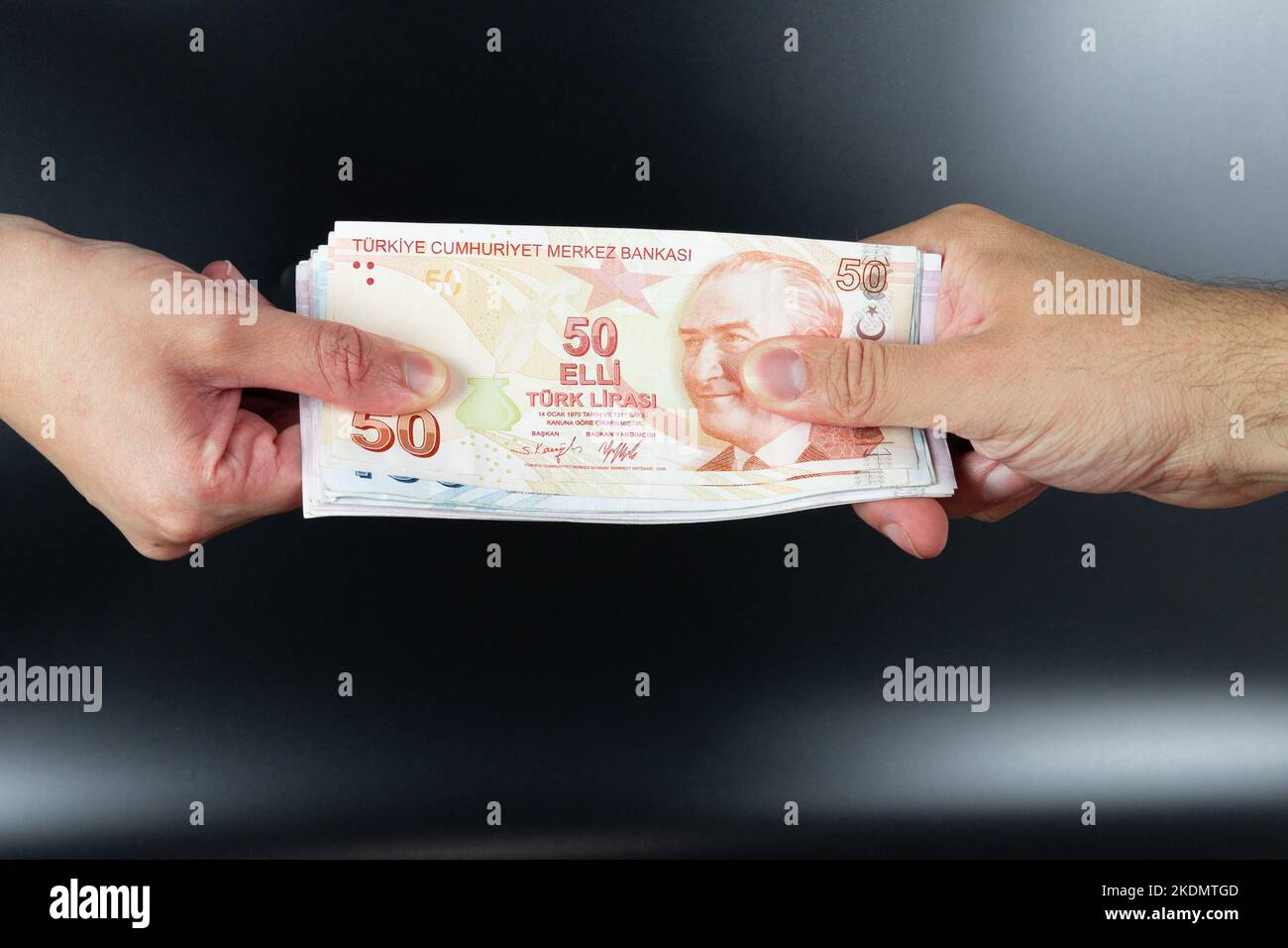 Human hands exchanging money isolated on background. Turkish money or Turkish lira. Stock Photo