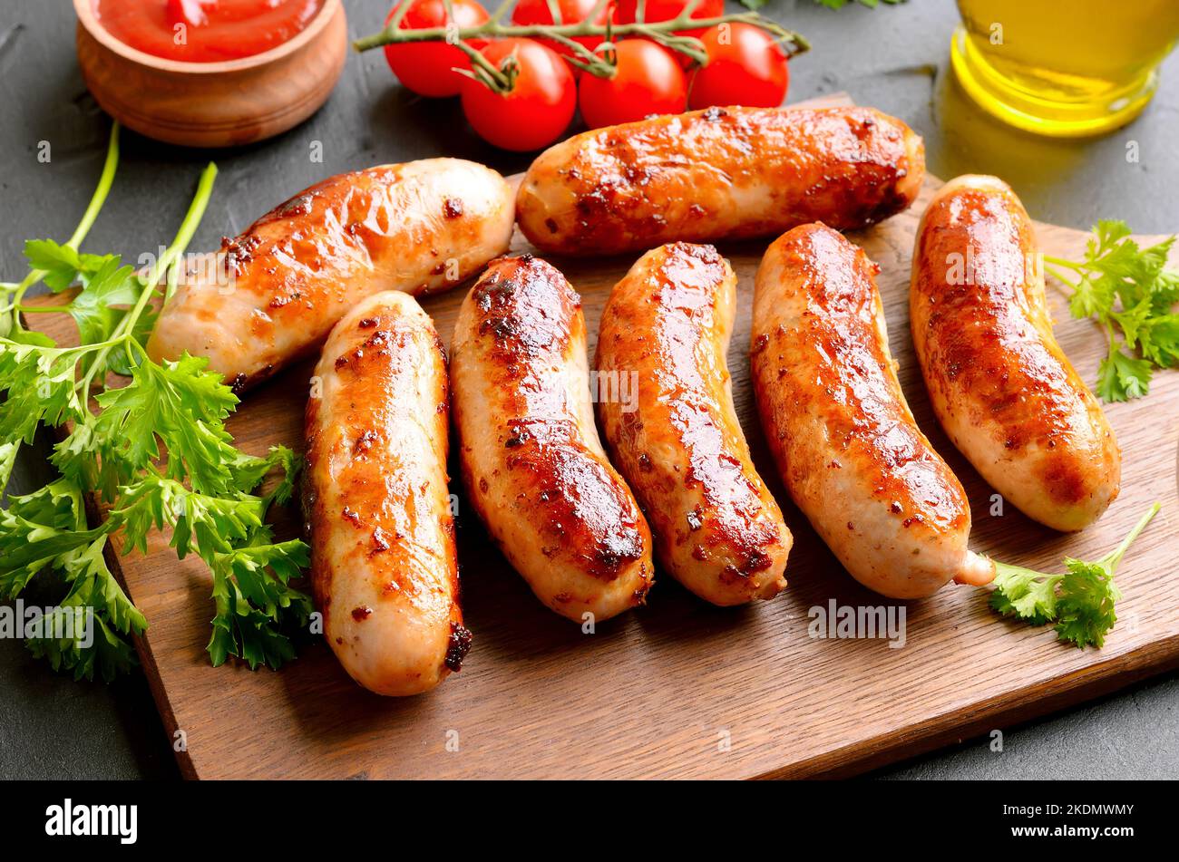 Homemade fried bratwurst on cutting board, close up view Stock Photo