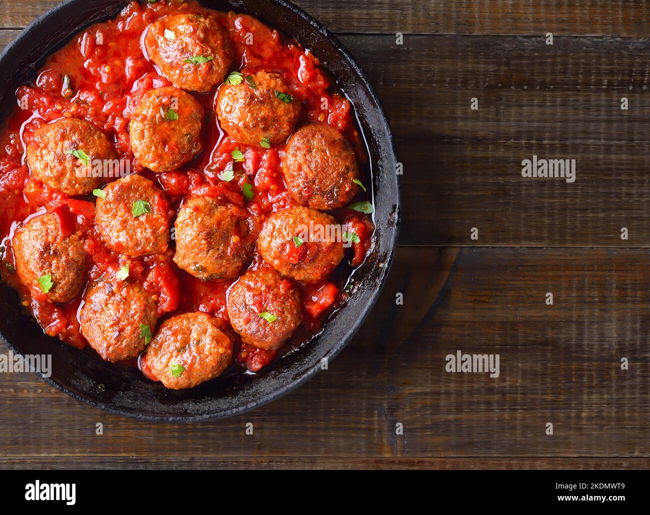 Fried meatballs with tomato sauce in frying pan. Top view, flat lay Stock Photo