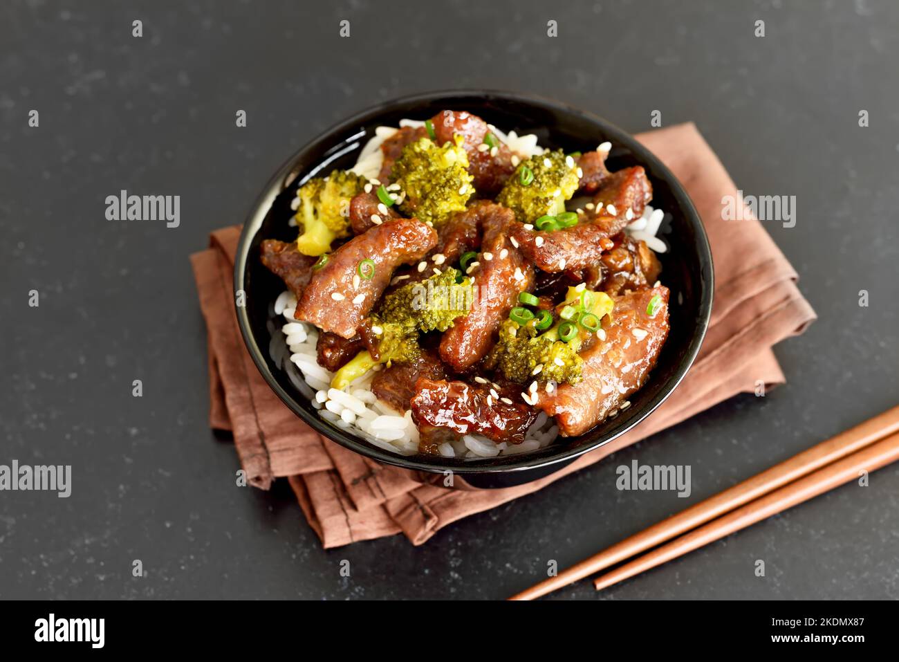 Beef and broccoli stir fry with rice in bowl Stock Photo