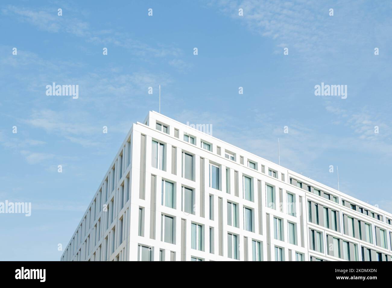 Modern office building on a blue sky background Stock Photo - Alamy