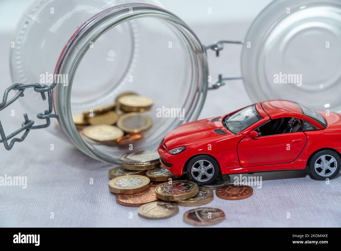 Car on coins; Car loan, Finance, saving money, insurance and leasing time concepts Stock Photo