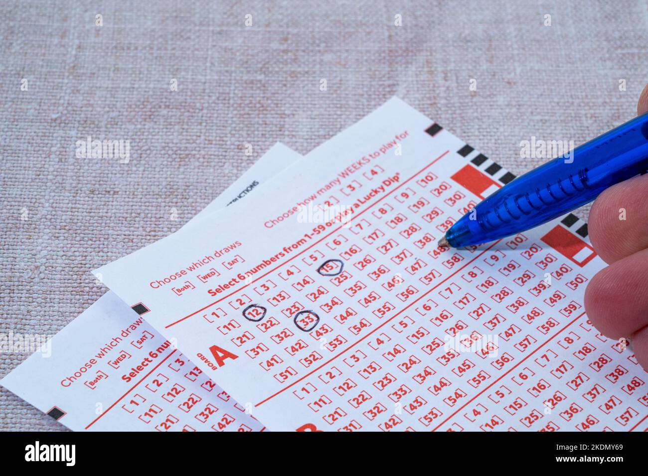 Pen  marking numbers on a lottery ticket Stock Photo