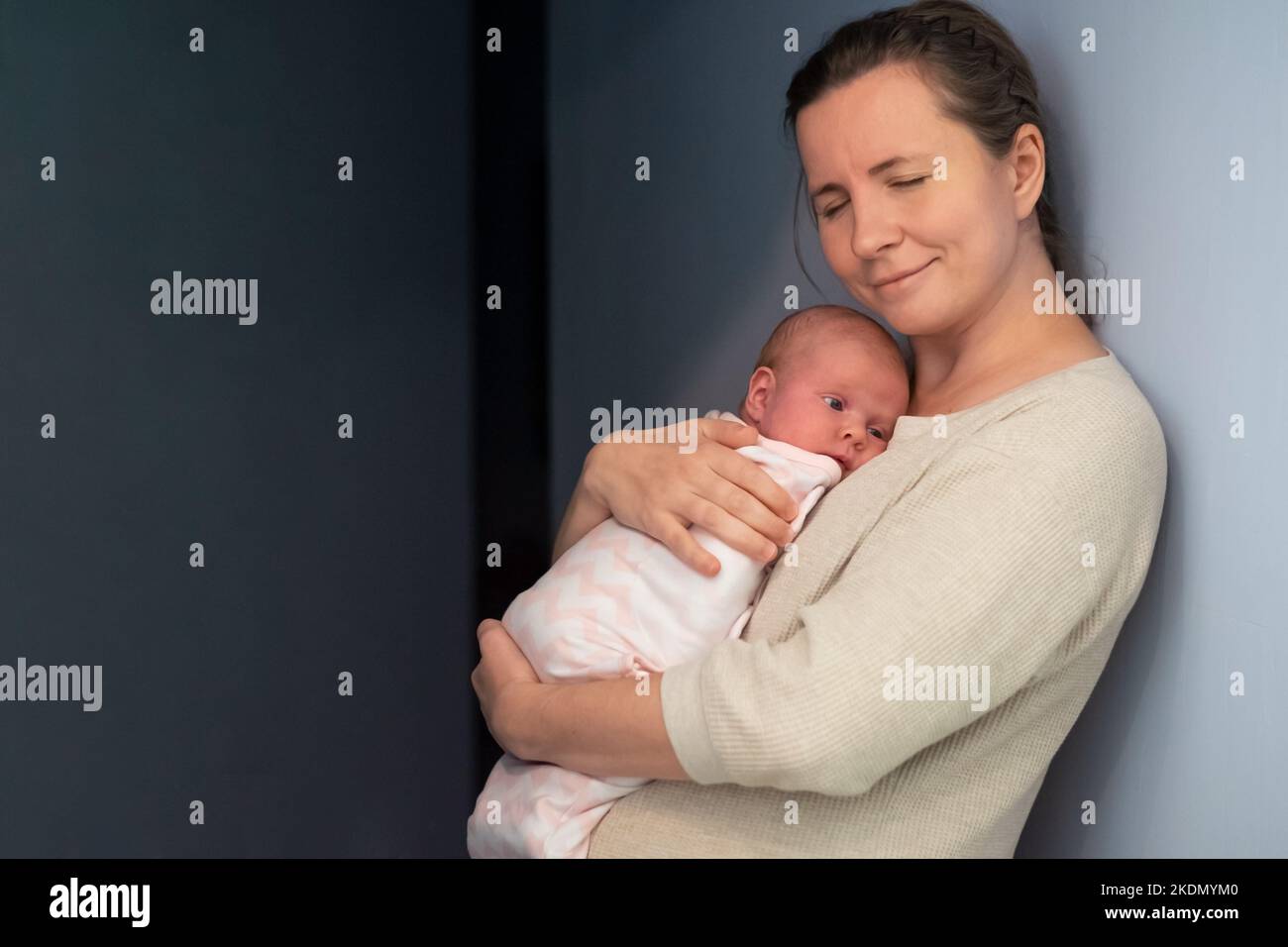 Caring young mother hold lean to chest newborn. Relax enjoy tender
