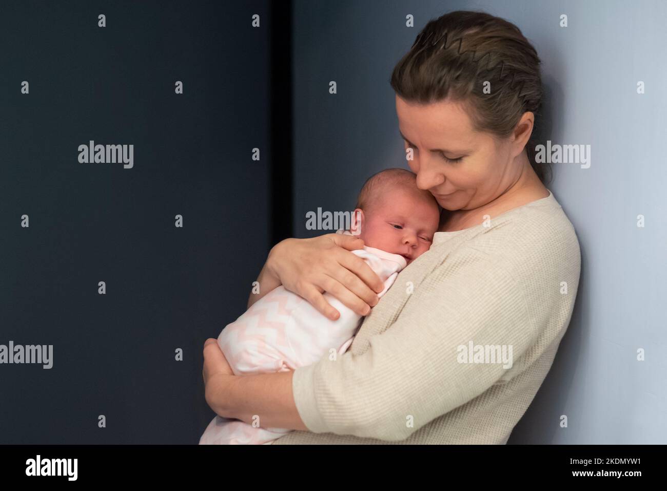 Caring young mother hold lean to chest newborn. Relax enjoy tender