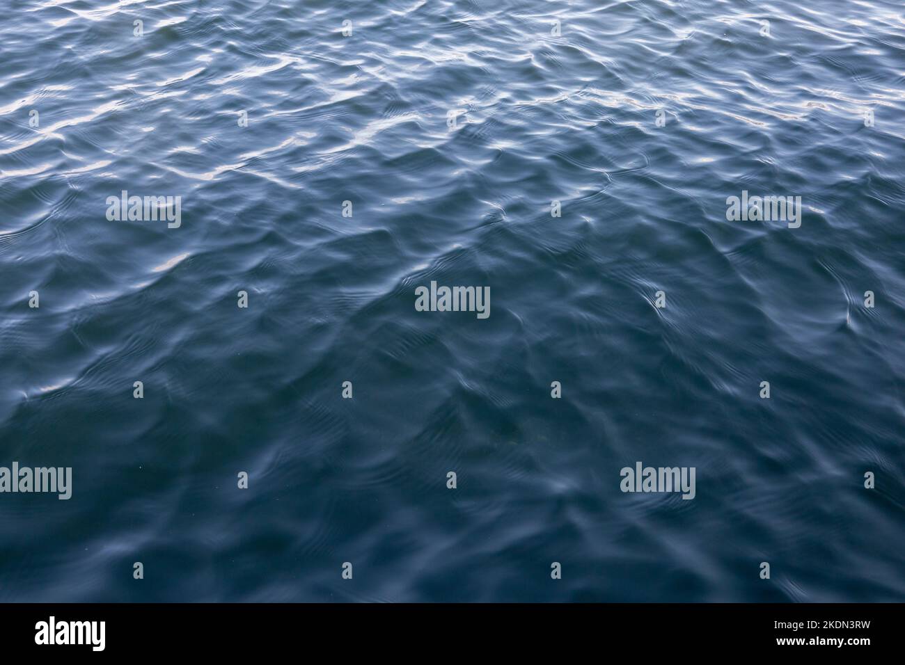 Water waves on the sea. Ripples on sea texture pattern background or wallpaper. Stock Photo