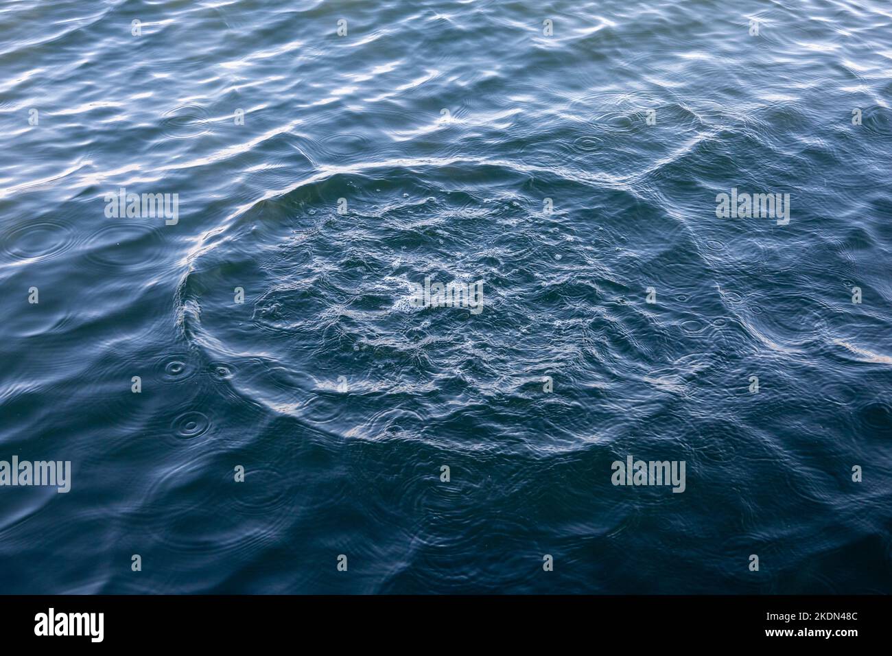 Water circles on the sea. Water rings after throwing a stone. Background or wallpaper. Stock Photo