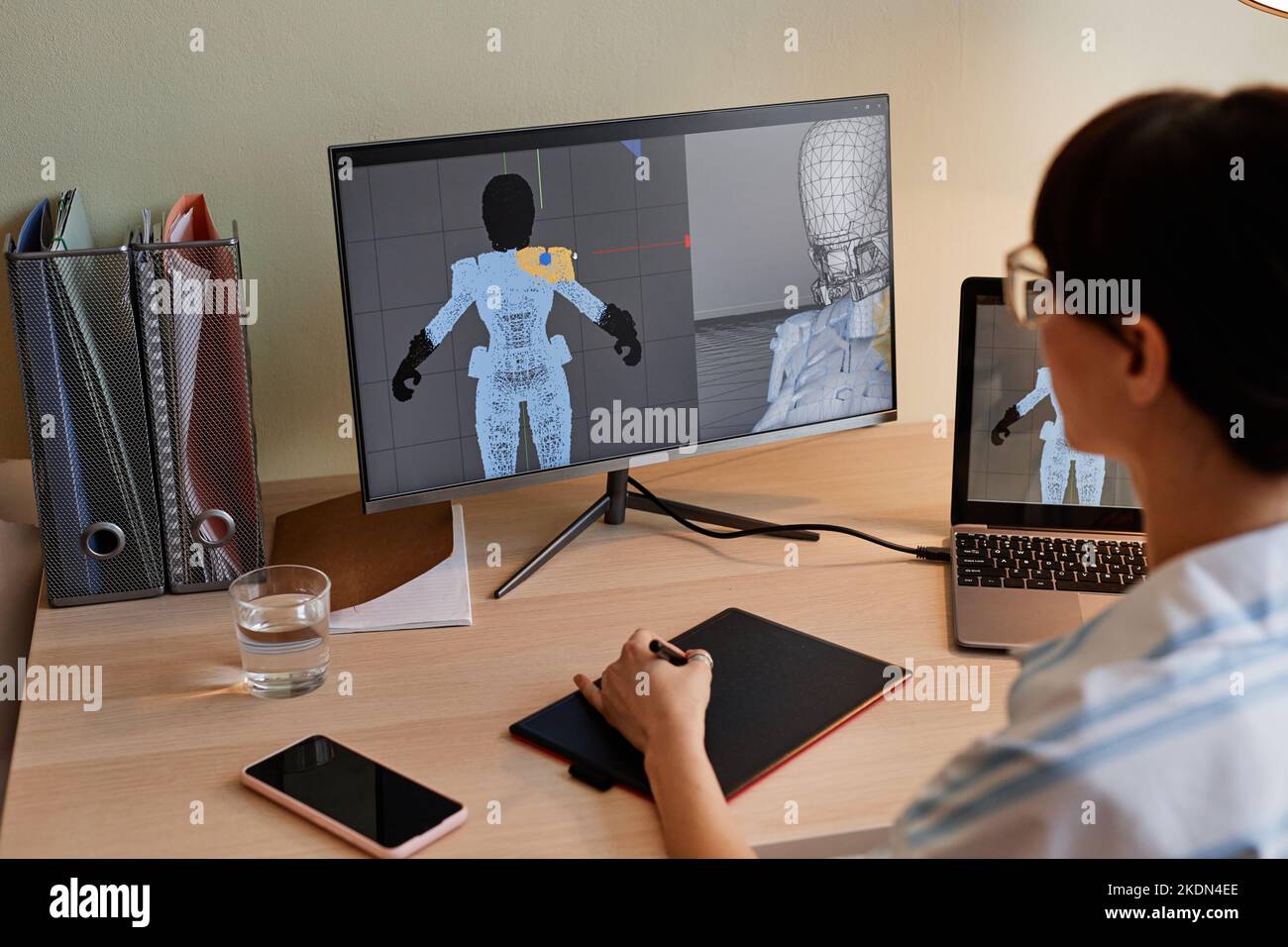 Close up of female designer building digital 3D models for videogame characters at workplace Stock Photo