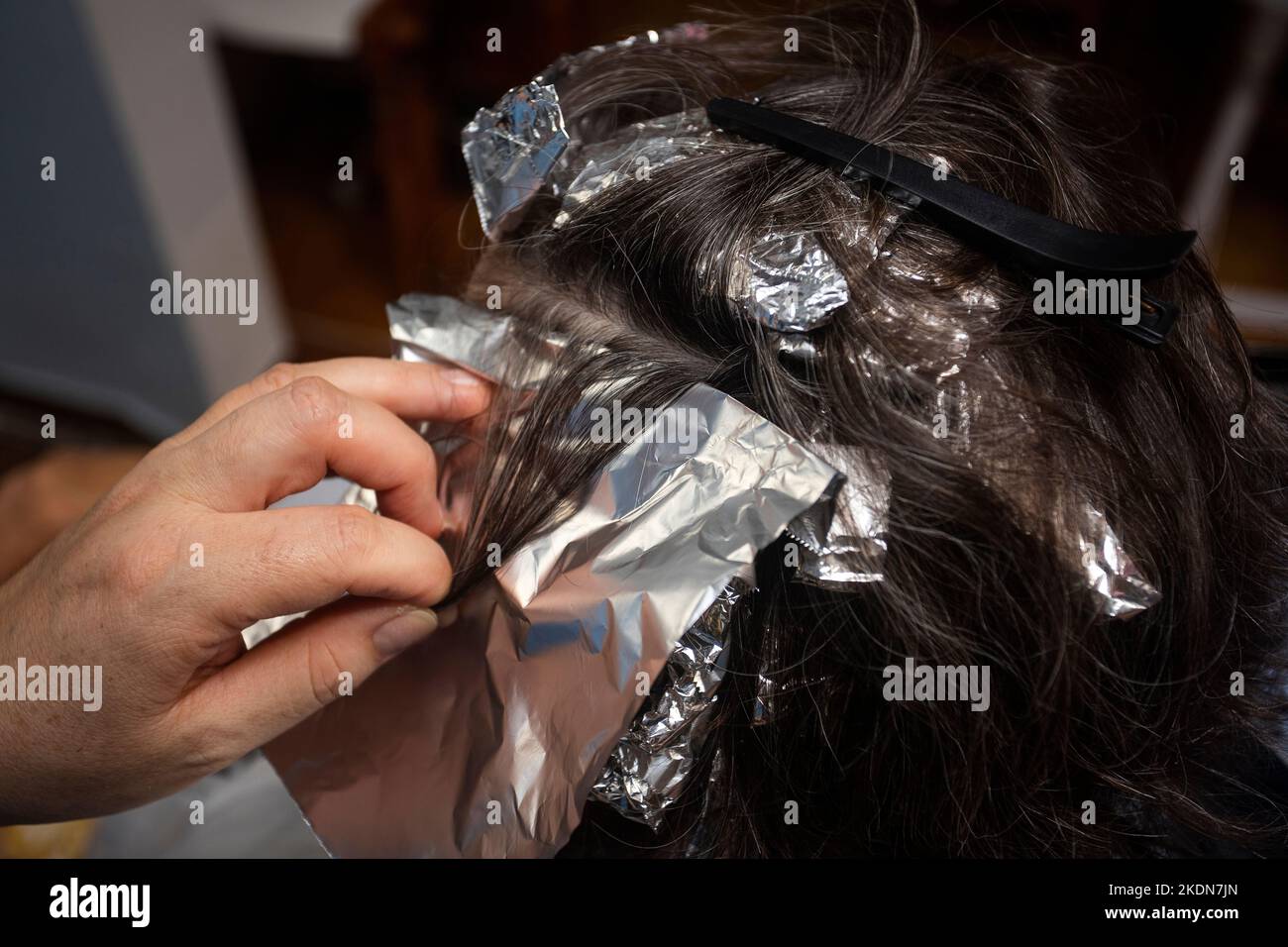 Bleaching woman's hair in the hairdressing salon Chemical dye Stock