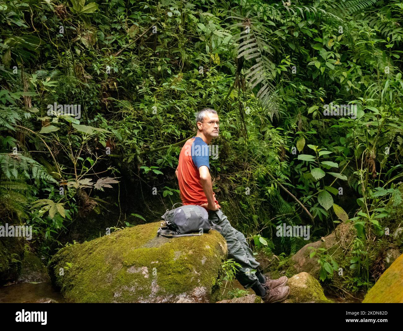 Envigado, Antioquia, Colombia February 27 2020 White Man Wears Glasses, Rests on a Rock to