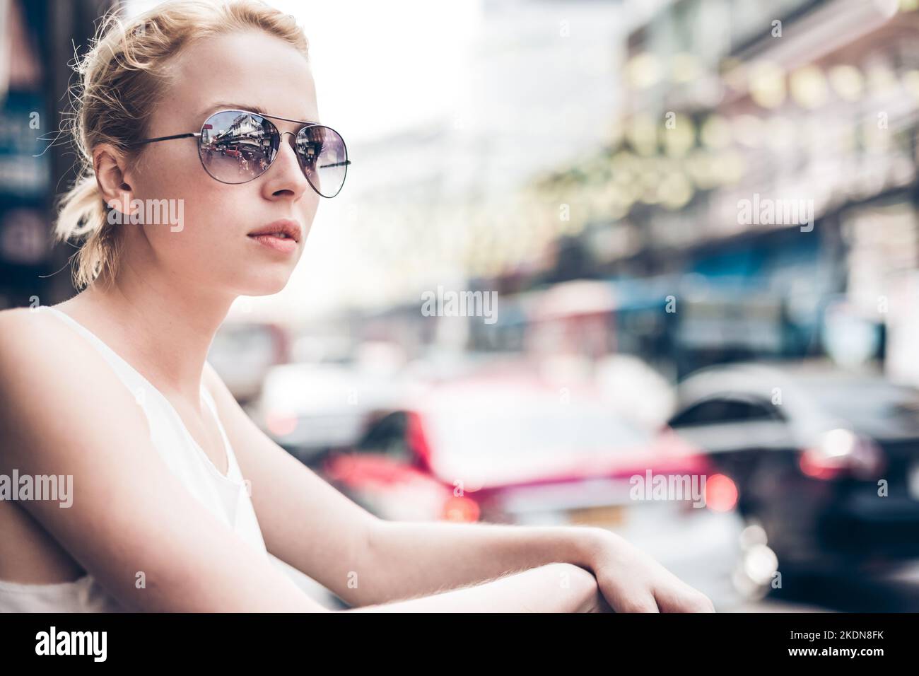 Portrait of Caucasian, Blonde, Female Traveler on the street of Bangkok, Thailand. Street shot. Stock Photo