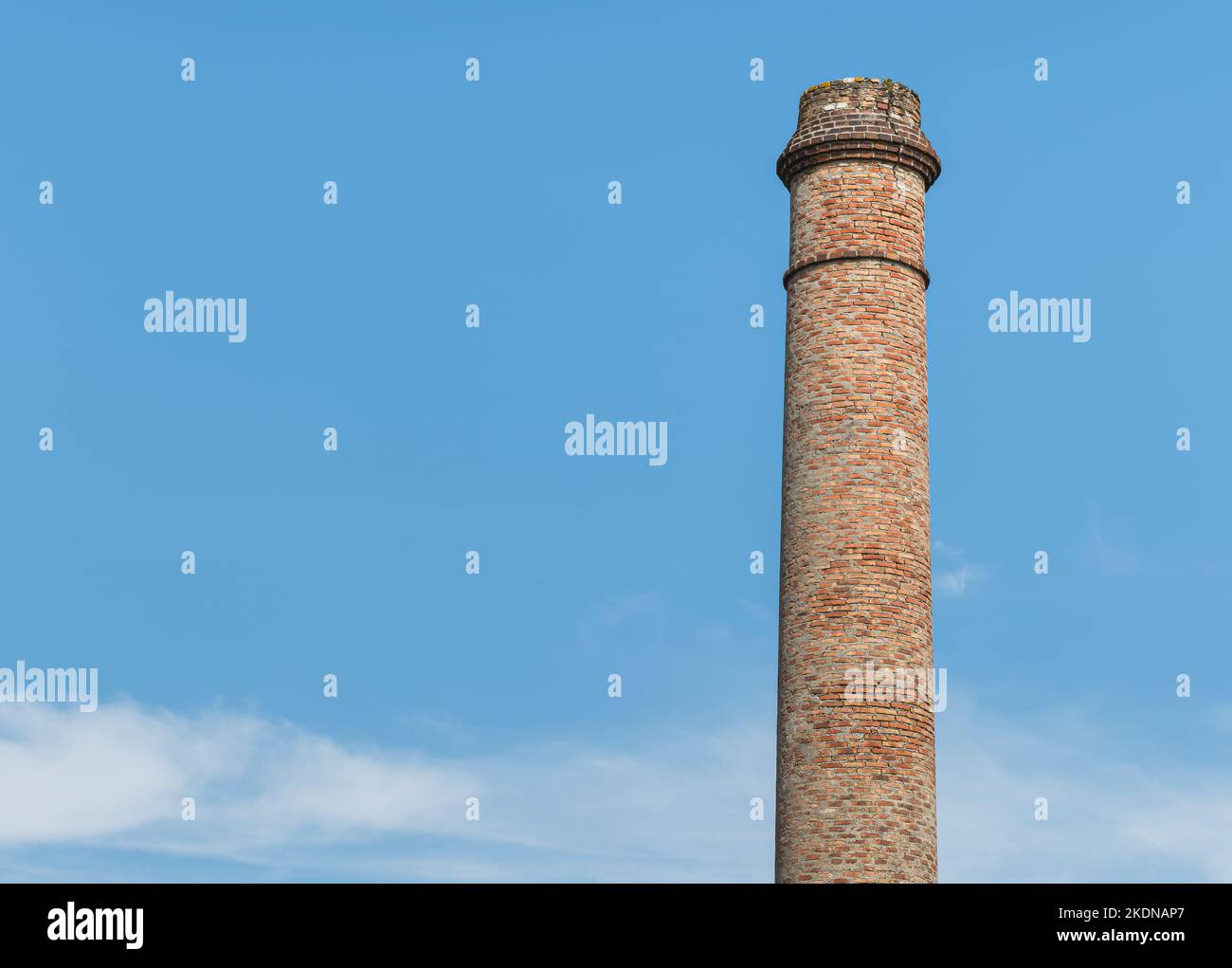 old abandoned fireplace made with red bricks on blue sky in Spain Stock Photo