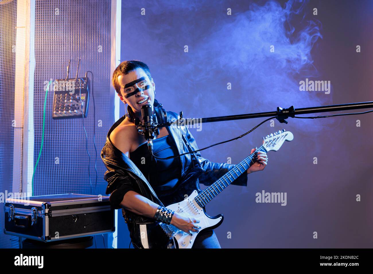 Punk rock singer performing heavy metal music with guitar, playing cool