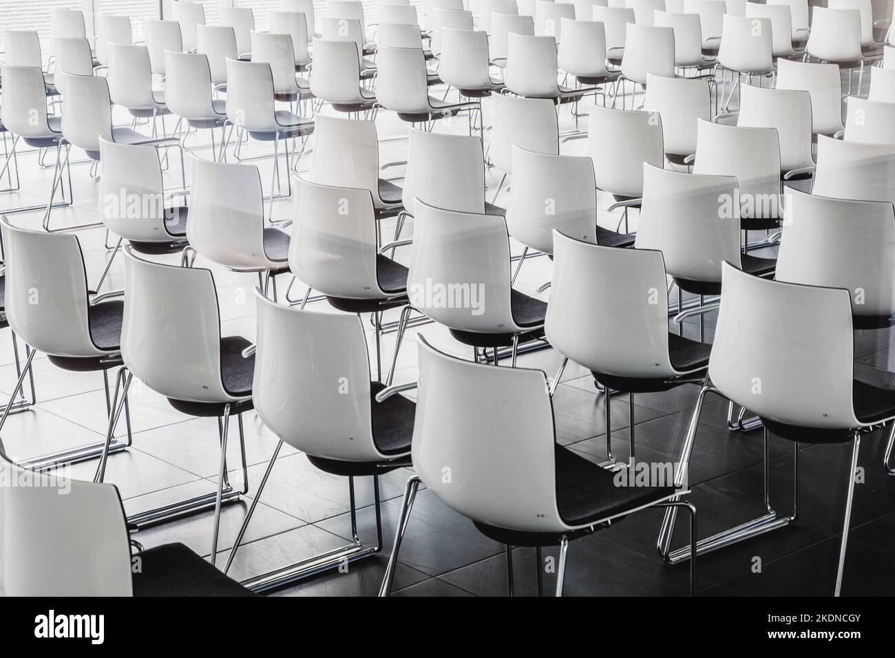 Interior of empty contemporary conference hall with white chairs. Stock Photo