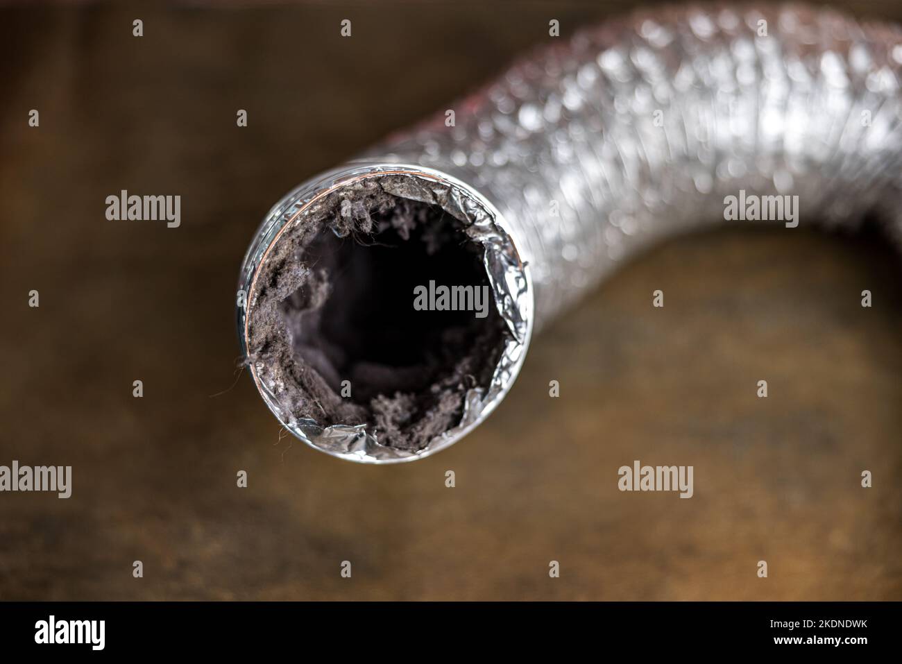 A dirty laundry flexible aluminum dryer vent duct ductwork filled with lint, dust and dirt Stock