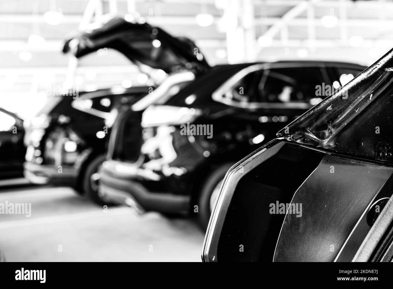 Open truck at a car rental return center where rows of vehicles are