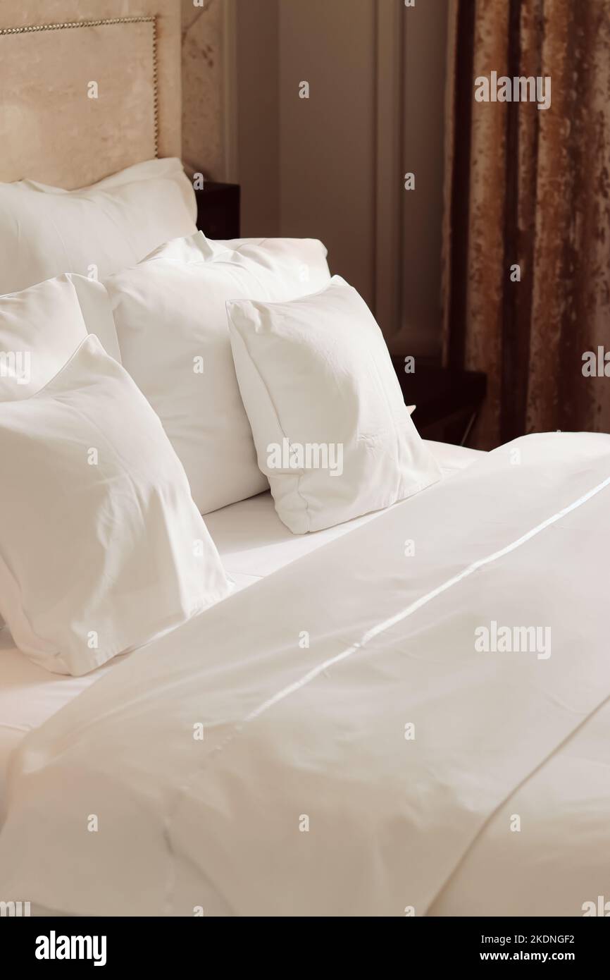 Home decor and interior design, bed with white bedding in luxury