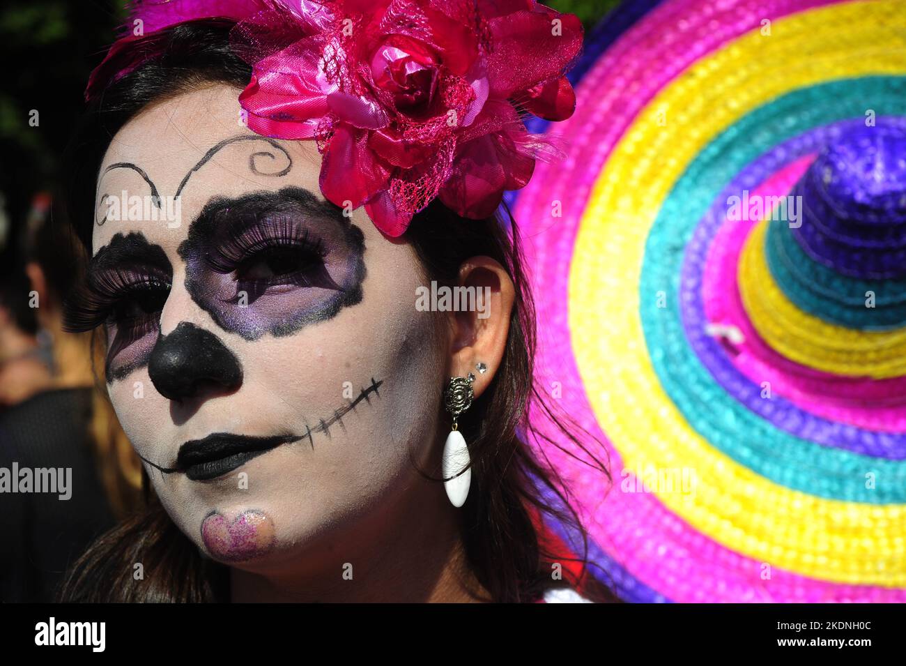 Mexican skull face paint Day of the Dead inspired. Brazilian girls on costume during carnival. Revellers party on street parade Stock Photo