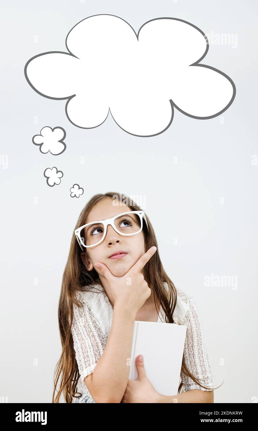 beautiful little girl with glasses looking up and thinking Stock Photo