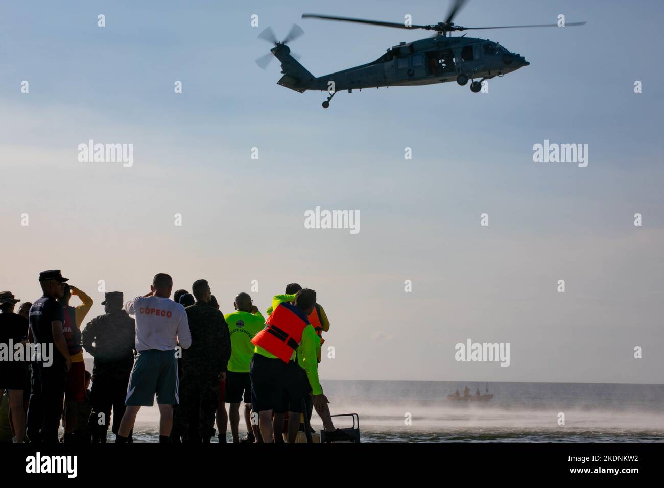 PUERTO CORTES, Honduras (Nov. 4, 2022) An MH-60S Seahawk, attached to the 'Chargers' of Helicopter Sea Combat Squadron (HSC) 26 onboard the hospital ship USNS Comfort (T-AH 20), fly's over observers of the search and rescue exercise at Puerto Cortes Naval Base in Puerto Cortes, Honduras, Nov. 4, 2022. Comfort is deployed to U.S. 4th Fleet in support of Continuing Promise 2022, a humanitarian assistance and goodwill mission conducting direct medical care, expeditionary veterinary care, and subject matter expert exchanges with five partner nations in the Caribbean, Central and South America. (U. Stock Photo