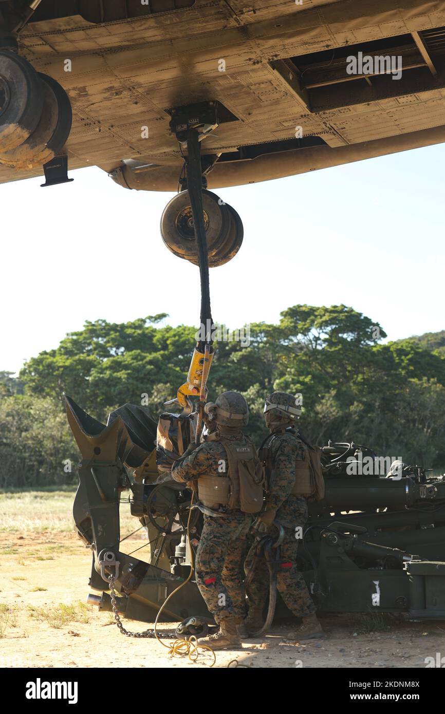 U.S. Marines with 3rd Battalion, 12th Marines attach an M777 Howitzer to a CH-53E Super Stallion during a training event at Camp Hansen, Okinawa, Japan, Nov. 3, 2022. The training increased battlefield proficiency and combat readiness across Marine Air-Ground Task Force units while expanding the ability for commanders to relocate artillery assets in austere terrain. (U.S. Marine Corps photo by Lance Cpl. Eduardo Delatorre) Stock Photo