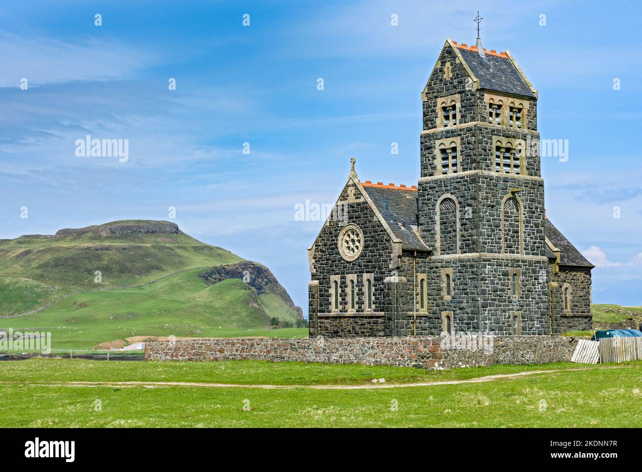 The former church of St. Edward on the Isle of Sanday, Scotland, UK.  Behind is Compass Hill on the Isle of Canna. Stock Photo