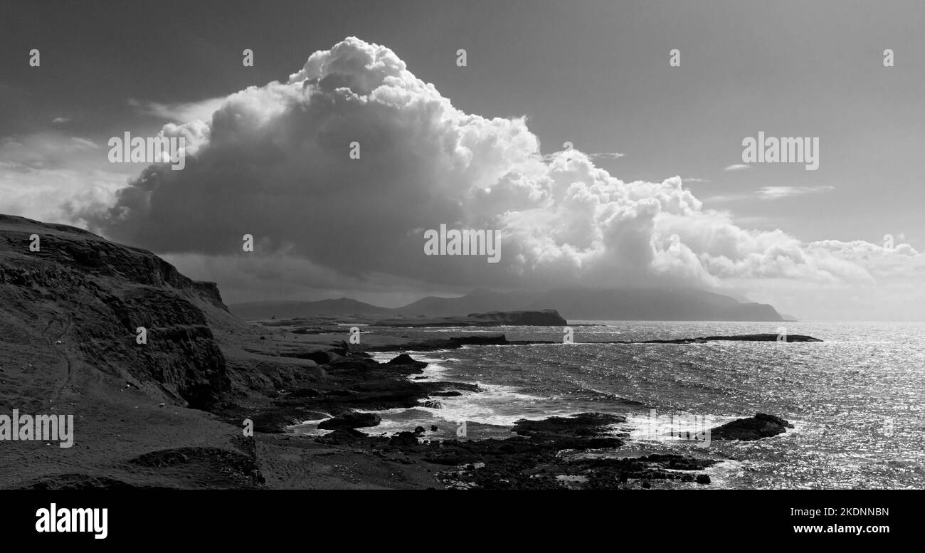 Dramatic clouds over the Isle of Rum, from near Tarbert Bay on the south coast of the Isle of Canna, Scotland, UK. Stock Photo