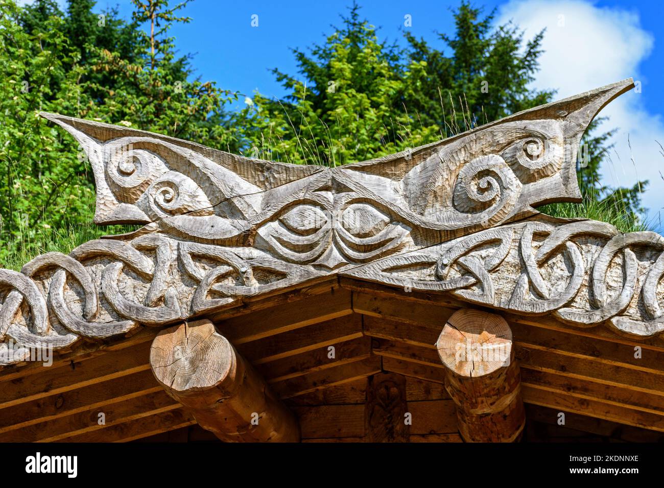 Wood carvings on the roof of the log cabin in Community Forest
