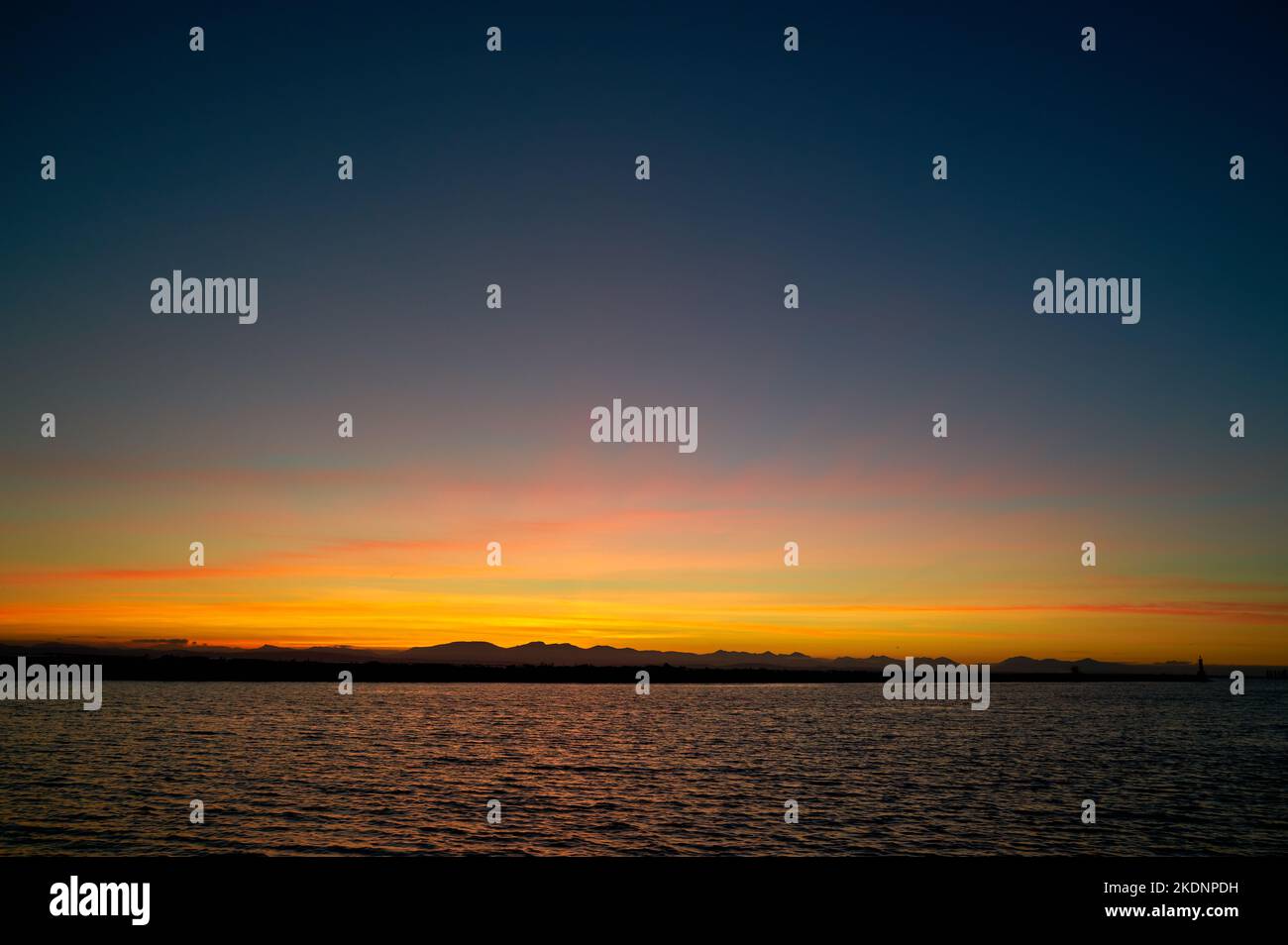 Salish Sea Sunset Strait of Georgia. Sunset over the Georgia Strait and the Salish Sea from the mouth of the Fraser River. Stock Photo