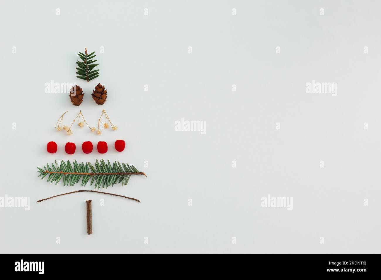 Christmas tree made with evergreen fir, pine cones, red berries and ...