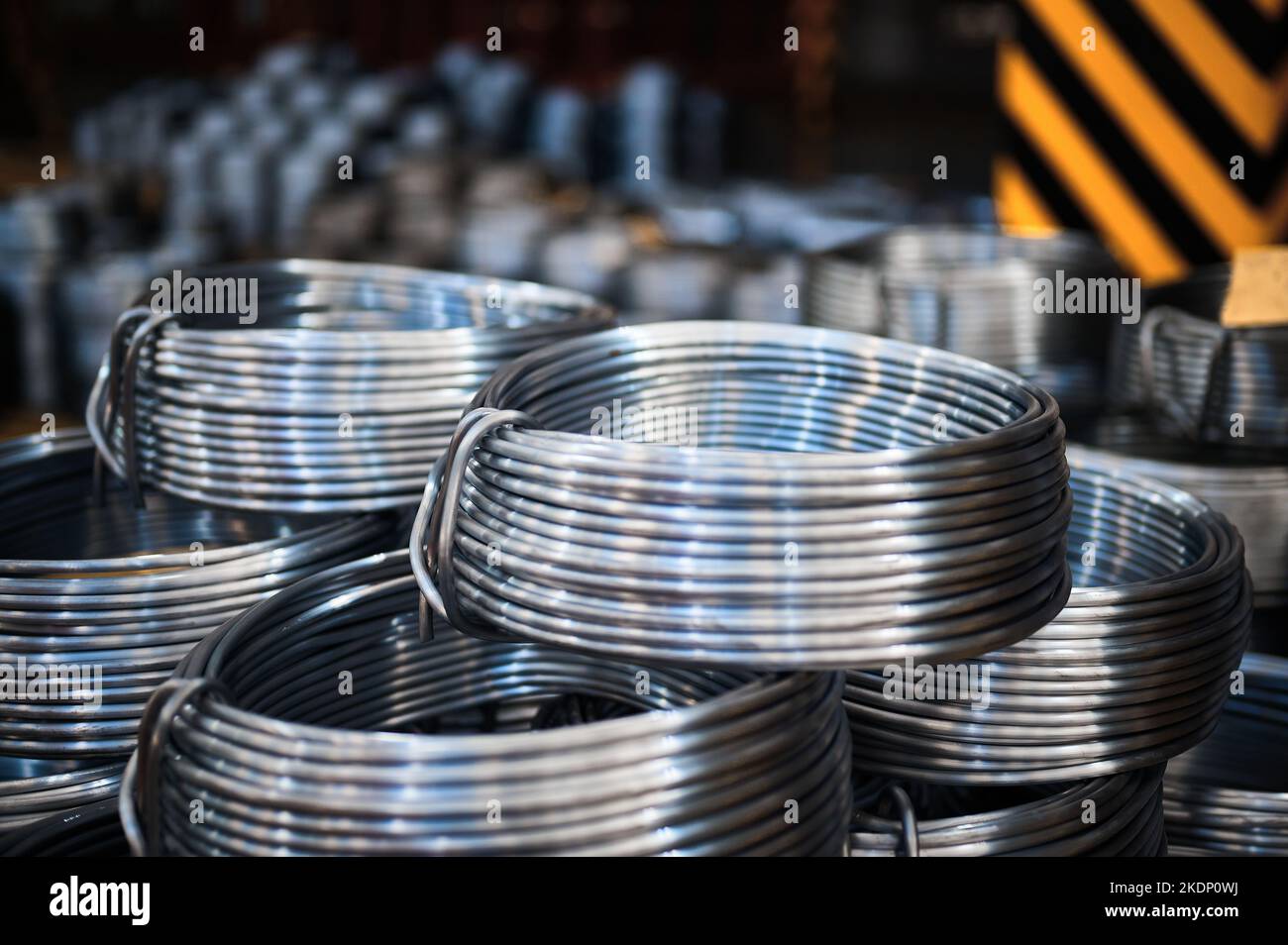 Coils of grey lead rod for bullets production at plant Stock Photo - Alamy