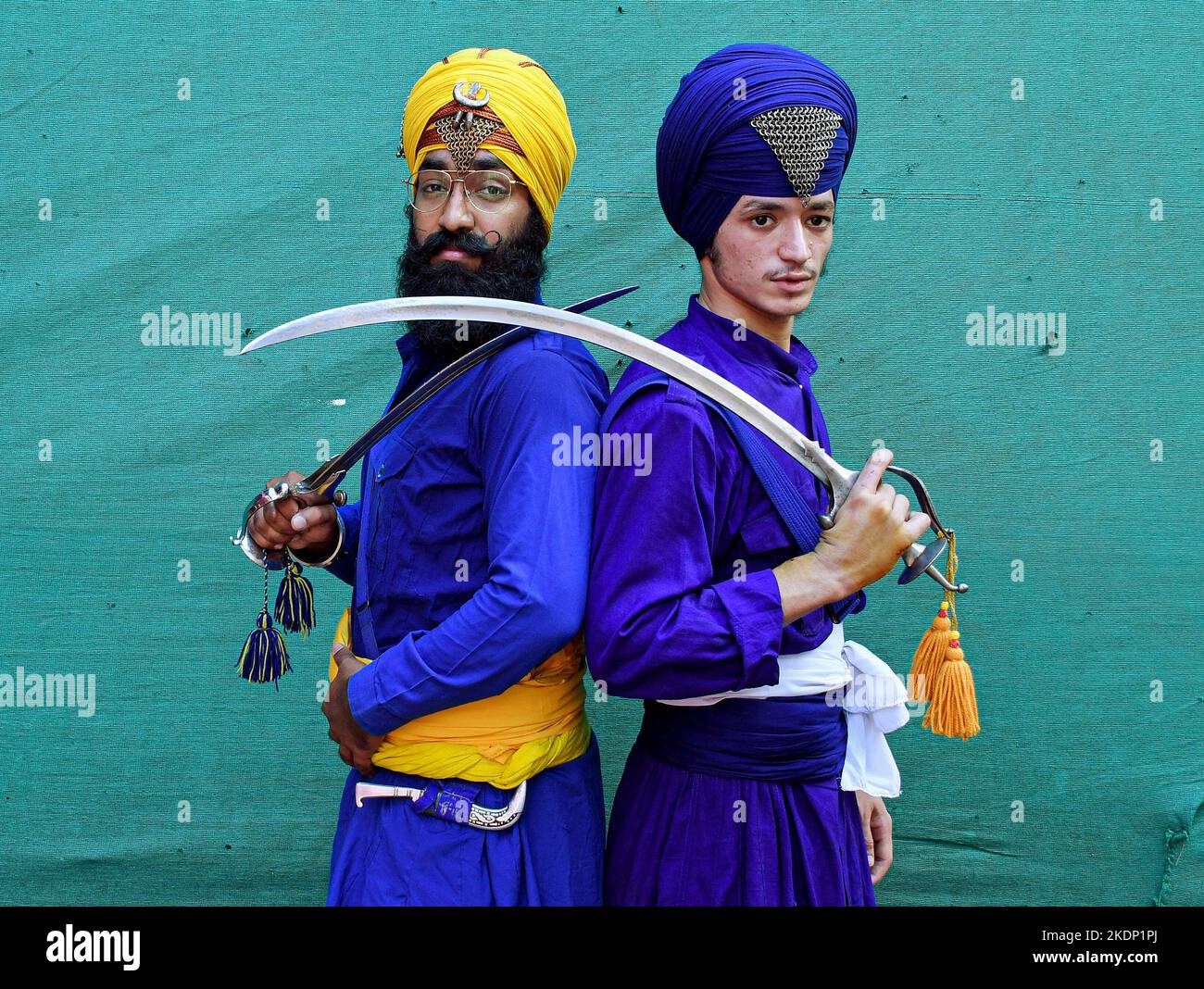 Nihangs or Sikh warriors pose for a photo while holding swords ahead of the birthday celebration of Guru Nanak Dev Ji in Mumbai. Gatka is a Punjabi word that translates to wooden sticks, which are used instead of swords. it uses a sword as the main weapon, amongst others. person's spiritual and physical aspect is developed during the learning phase of this ancient art. Gatka was extensively used by Sikh warriors to defend themselves from the atrocities of the Mughals and the British rulers. (Photo by Ashish Vaishnav/SOPA Images/Sipa USA) Stock Photo