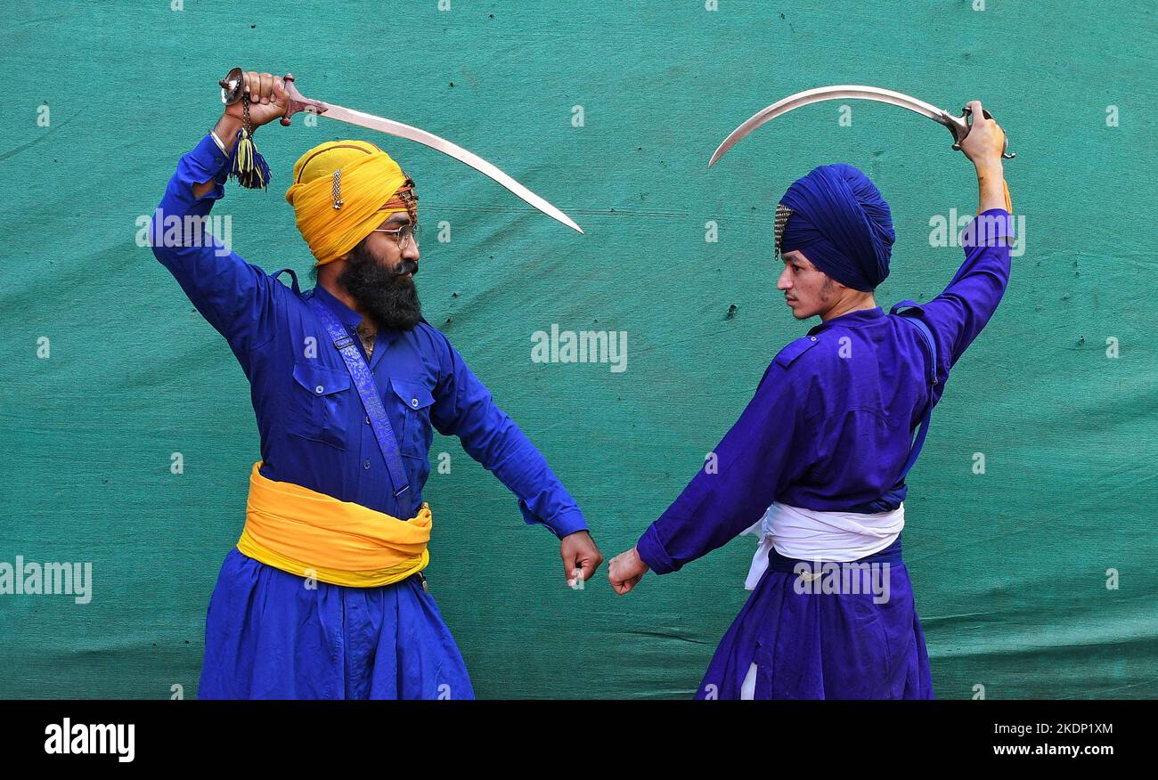 Nihangs or Sikh warriors pose for a photo while holding swords ahead of the birthday celebration of Guru Nanak Dev Ji in Mumbai. Gatka is a Punjabi word that translates to wooden sticks, which are used instead of swords. it uses a sword as the main weapon, amongst others. person's spiritual and physical aspect is developed during the learning phase of this ancient art. Gatka was extensively used by Sikh warriors to defend themselves from the atrocities of the Mughals and the British rulers. (Photo by Ashish Vaishnav/SOPA Images/Sipa USA) Stock Photo