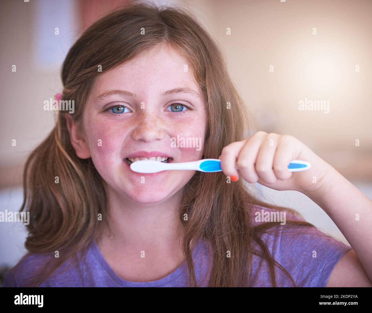 Keeping my teeth in tip-top shape. a little girl brushing her teeth. Stock Photo