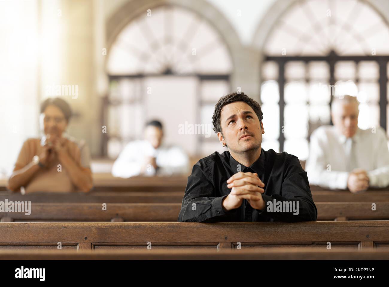 Church, prayer and man faith, religion or hope for spiritual healing, help and talking to god thinking of life problem. Christian group people praying Stock Photo
