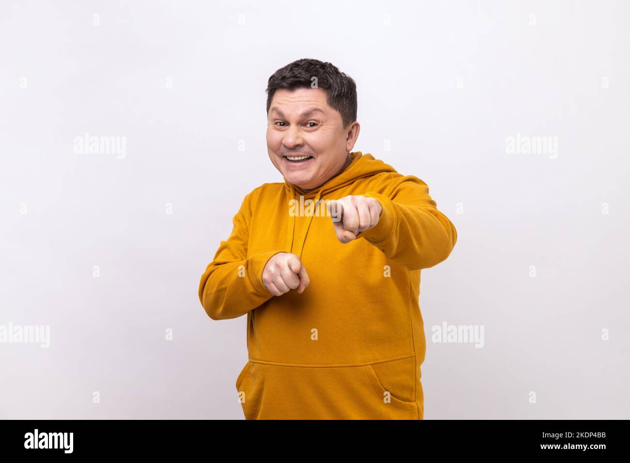 You are special. Positive happy man pointing fingers at camera and looking with toothy smile, believes in you, motivation, wearing urban style hoodie. Indoor studio shot isolated on white background. Stock Photo