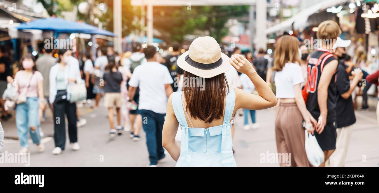 woman traveling with hat, Asian traveler standing at Chatuchak Weekend Market, landmark and popular for tourist attractions in Bangkok, Thailand. Trav Stock Photo