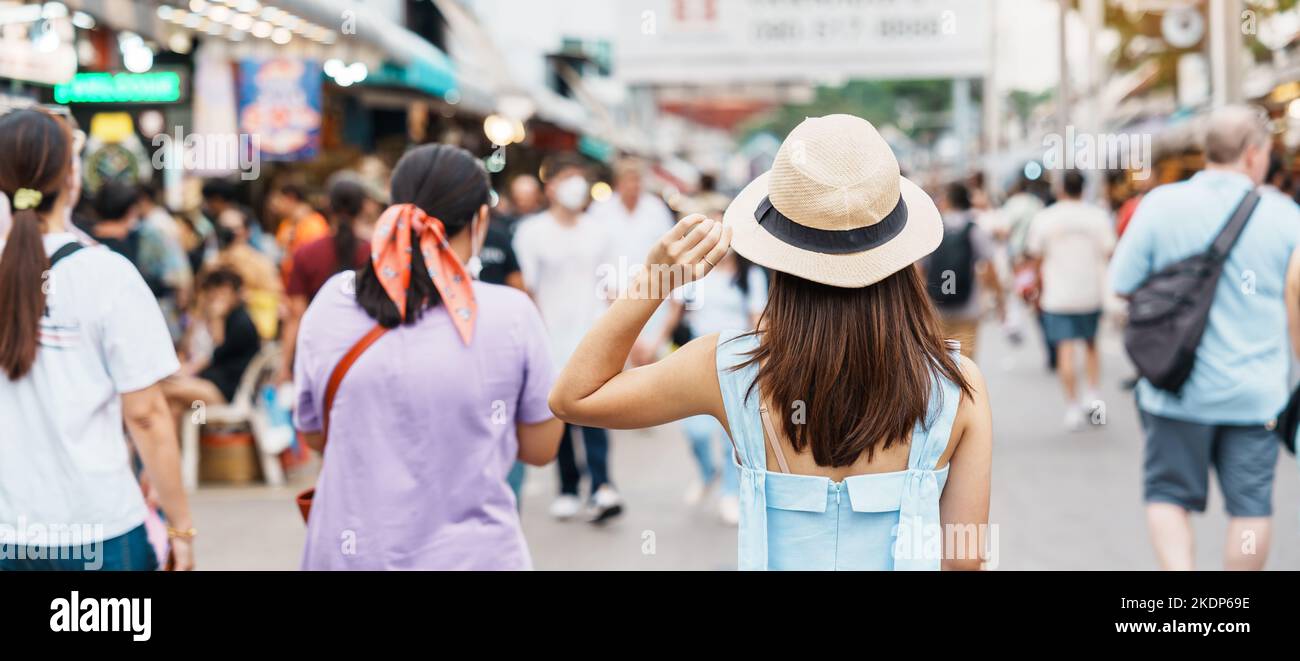 woman traveling with hat, Asian traveler standing at Chatuchak Weekend Market, landmark and popular for tourist attractions in Bangkok, Thailand. Trav Stock Photo