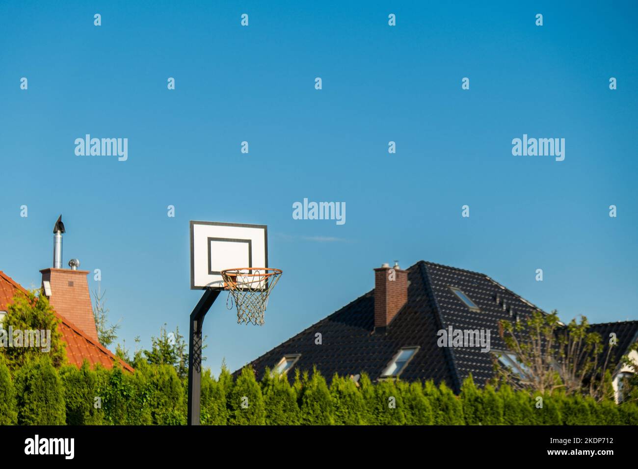 Street basketball hoop on background of vibrant sky. Creative minimalistic photo. Street Basketball Loop Basket Outdoors Abstract sport wide blank empty background texture, copy space. Sports, leisure activities creative bright backgrounds concept Stock Photo